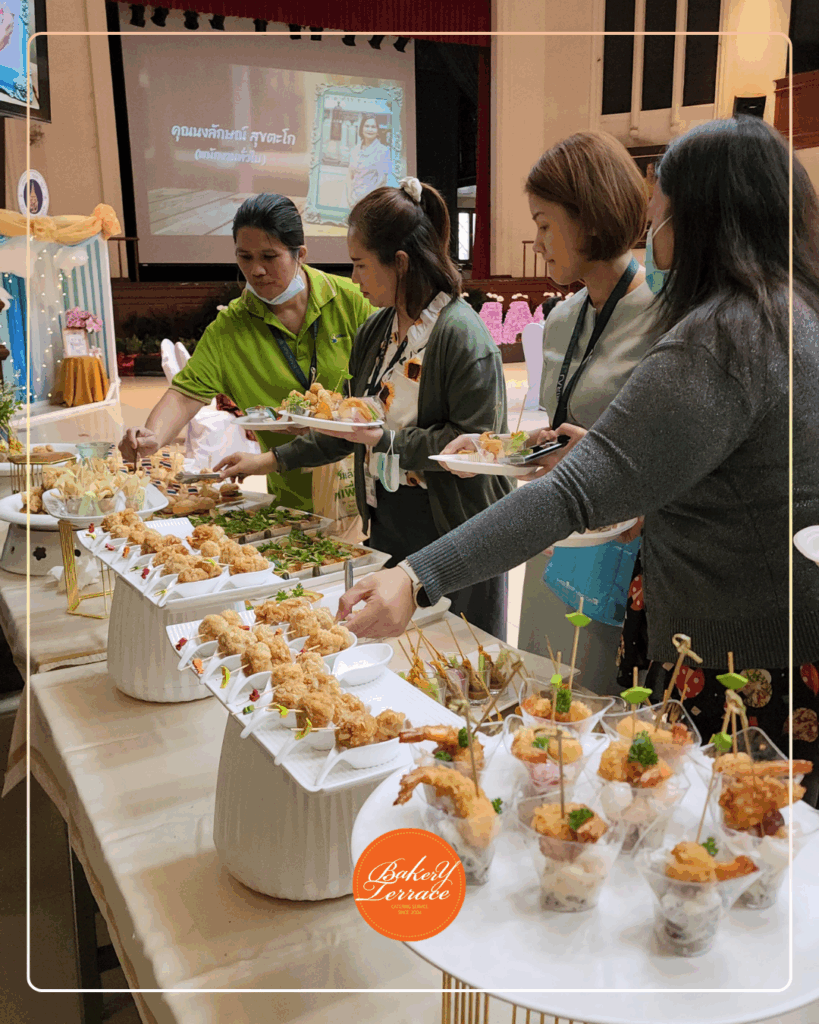 People serving food at a buffet. ร้านเบเกอร์รี่เทอเรส รับจัดอาหารนอกสถานที่ food cocktail / finger foods